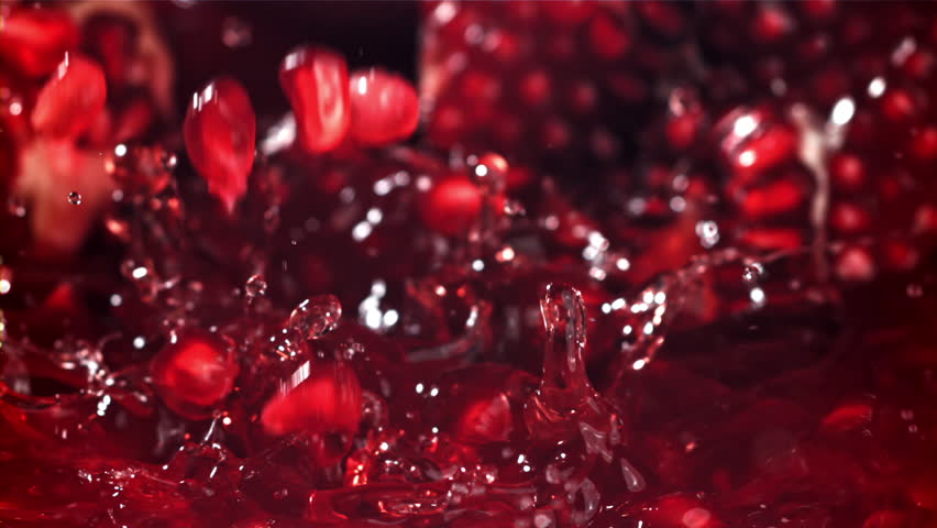 Pomegranate seeds fall into the juice. Filmed on a high-speed camera at 1000 fps. High quality FullHD footage