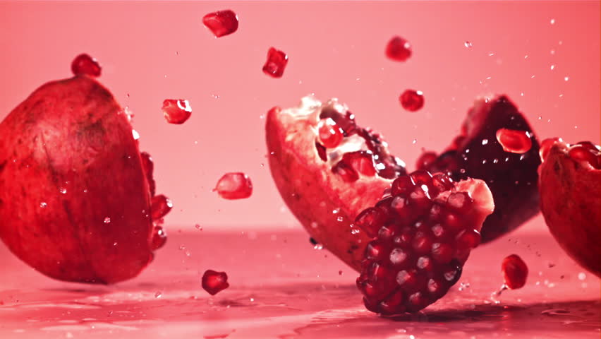 Chunks of fresh pomegranate fall on the table. Filmed on a high-speed camera at 1000 fps. High quality FullHD footage