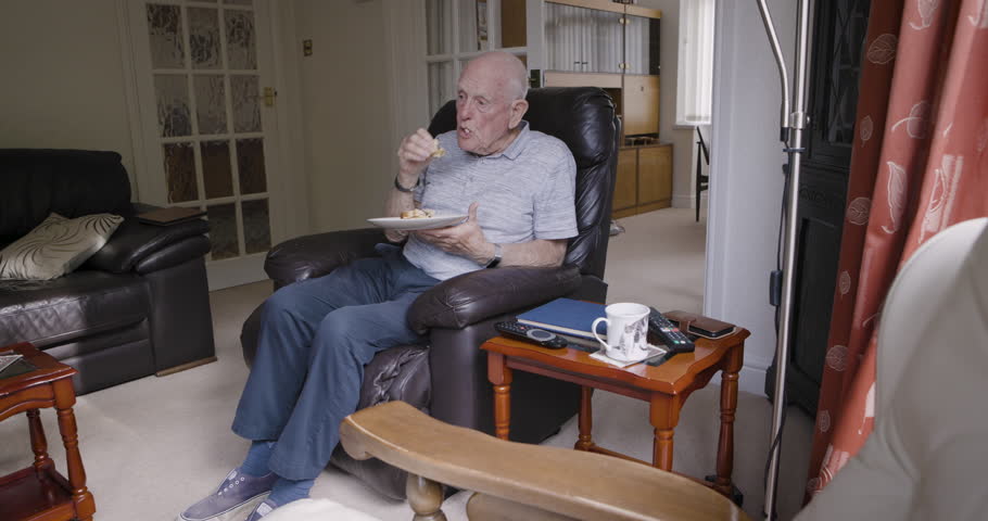 Breakfast, coffee and senior man eating in home living room alone after rehabilitation session. Health, nutrition and retired elderly male from Canada having food, drinking tea and relaxing in house.