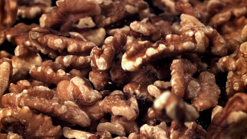 Walnuts fall into a wooden bowl. Filmed on a high-speed camera at 1000 fps. High quality FullHD footage