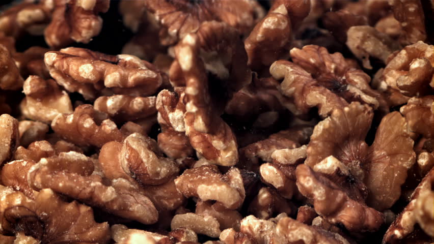 Walnuts fall into a wooden bowl. Filmed on a high-speed camera at 1000 fps. High quality FullHD footage