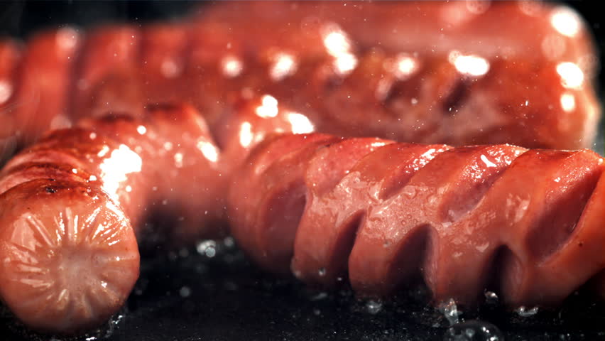 Sausages are fried with splashes in a pan. Filmed on a high-speed camera at 1000 fps. High quality FullHD footage