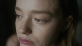 Extreme close-up shot of young tearful Caucasian woman with green eyes crying in pain after breakup and looking away, feeling vulnerable and lonely, missing ex-love - Powered by Shutterstock - Get 15% off with code: PIKWIZARD15