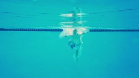 Child swimming in pool. Swimming underwater fun. Kid enjoying poolside. Active kid swimmer in water. Summer pool activities. Playful boy swimming in pool. Kid splashing in water. Fun kids swimming. - Powered by Shutterstock - Get 15% off with code: PIKWIZARD15
