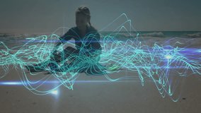 woman exploring technology data on shoreline, with glowing teal wave patterns overlaying her view. Marine, futurism, digital, innovation, serenity, tranquility, abstract - Powered by Shutterstock - Get 15% off with code: PIKWIZARD15