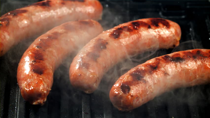 Sausages are fried with splashes in a pan. Filmed on a high-speed camera at 1000 fps. High quality FullHD footage