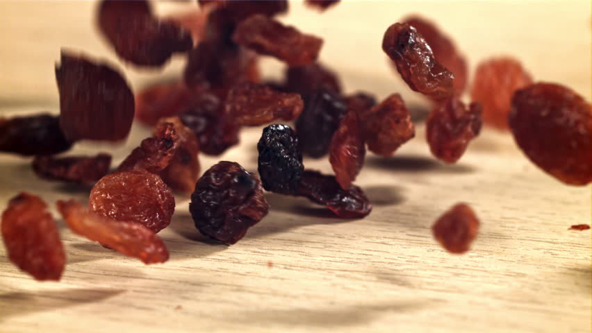 Raisins fall on the table. Filmed on a high-speed camera at 1000 fps. High quality FullHD footage