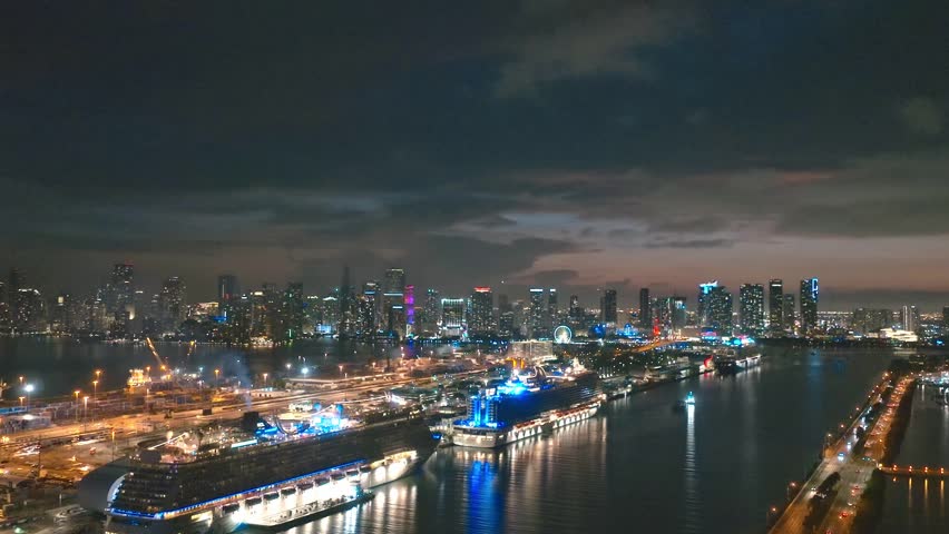 Miami Beach city at night with dramatic sky. Miami Beach seaside at dusk. Aerial view of evening Miami Beach and cityscape. Coastline of Miami Beach city, night shot. American city.