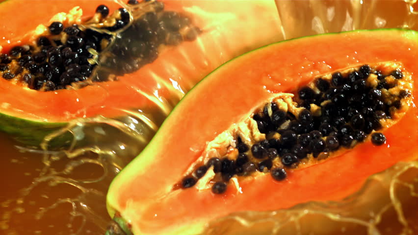 The papaya falls into the juice with splashes. Filmed on a high-speed camera at 1000 fps. High quality FullHD footage