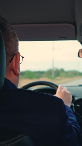Successful people driving their car. Business man drives car. Man travels by car outside city. Businessman in formal suit drives car to work. Luxurious Purchase rental insurance of transport vehicles