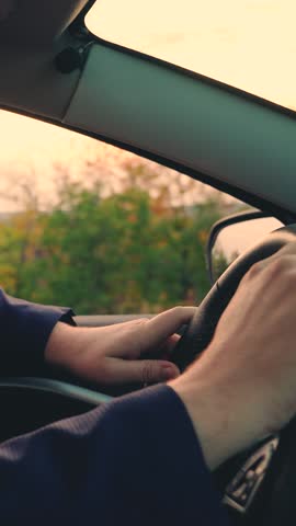 Business man drives car. Successful people driving their car. Male hands on steering wheel of car closeup, driver controls car. Man travels by auto. Purchase rental insurance of transport vehicles