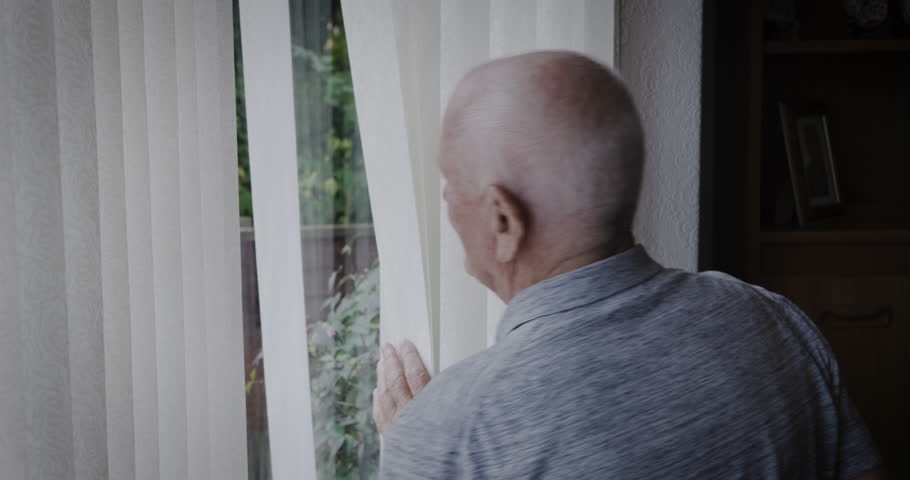 Senior man, window and waving hand while opening blinds to greet a neighbor or person with hello in morning during retirement. Elderly man in his Uk house to doing wave for kindness or goodbye