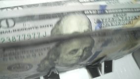 Closeup currency counting machine counting dollar. Slow motion of cash counting machine counts 100 dollar bills USD banknotes. Cash bill counter money machine. Finance banking credit deposit cash. - Powered by Shutterstock - Get 15% off with code: PIKWIZARD15
