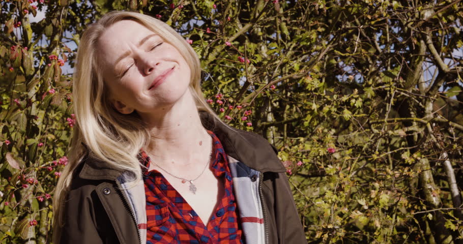 Woman, travel and face smile for nature, fresh air or sunshine getting vitamin D by countryside. Happy female traveler smiling in joyful happiness for calm relaxation, freedom or natural environment