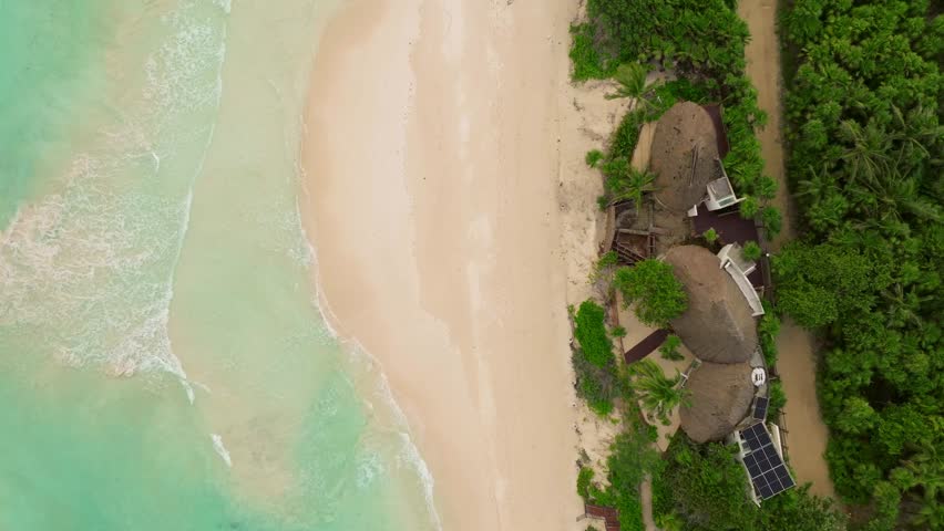 Aerial vertical fly clean resort white sand beach of Quintana Roo Tulum Mexico, revealing, rising up