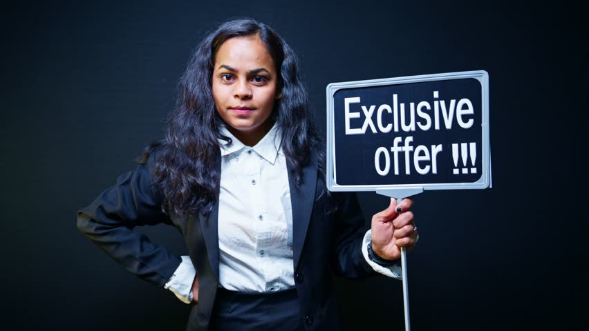Model pose gripping board showing Special Deal near shop, Woman wear suit holding exclusive offer signboard at mall, Promoter pointing signage stating limited time, Fashionable girl announce discount