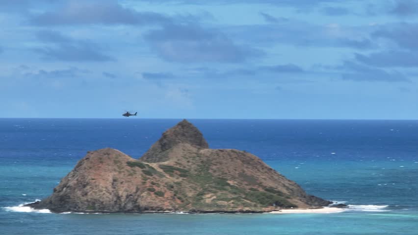 Epic Drone Shot of Military Helicopter Flying Around Island in Hawaii, Aerial Shot of Aircraft over Ocean Between Islands