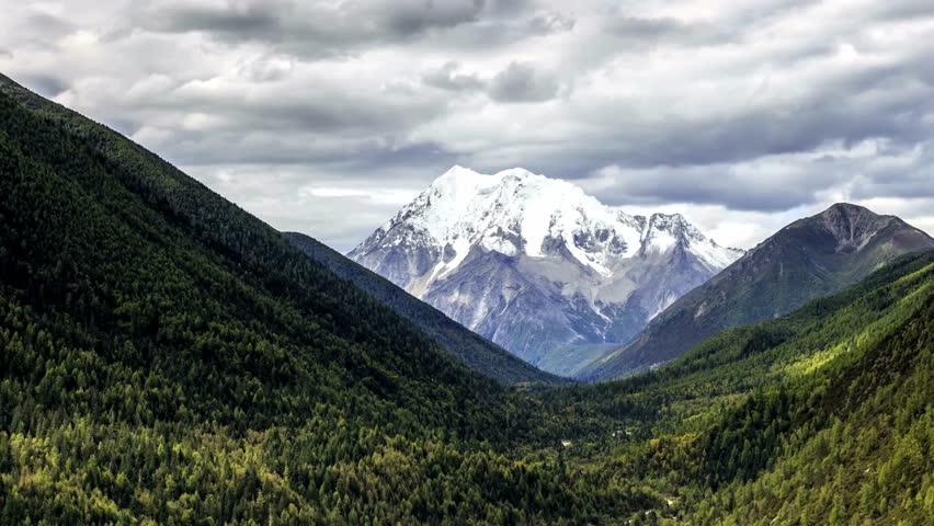 Majestic Snow-Capped Mountain Peak in Verdant Valley Landscape