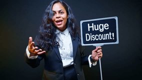 Woman holding huge discount signboard in exhibition, Promoter holds signage pointing massive deal at trade fair, Advertiser raises banner announcing best bargain, Model displays flash sale by showroom - Powered by Shutterstock - Get 15% off with code: PIKWIZARD15