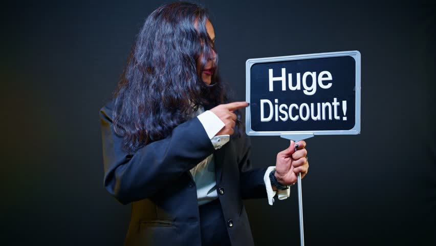 Promoter holds signage pointing massive deal at trade fair, Woman holding huge discount signboard in exhibition, Advertiser raises banner announcing best bargain, Model displays flash sale by showroom - Powered by Shutterstock - Get 15% off with code: PIKWIZARD15