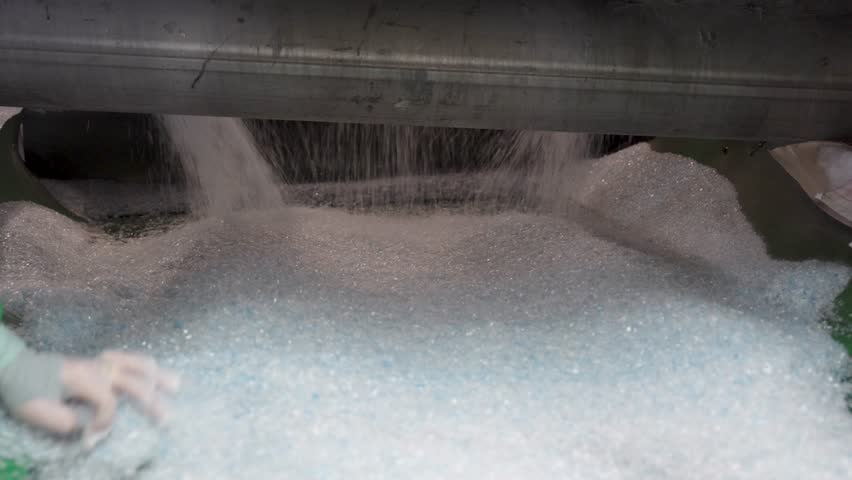 A detailed view inside a recycling center where plastic waste undergoes a fiber production process. Sustainability in focus.