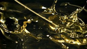 Olive oil with splashes on black background. Filmed on a high-speed camera at 1000 fps. High quality FullHD footage - Powered by Shutterstock - Get 15% off with code: PIKWIZARD15