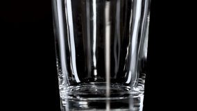 A sequence showing milk gradually filling a clear glass with a black backdrop. - Powered by Shutterstock - Get 15% off with code: PIKWIZARD15