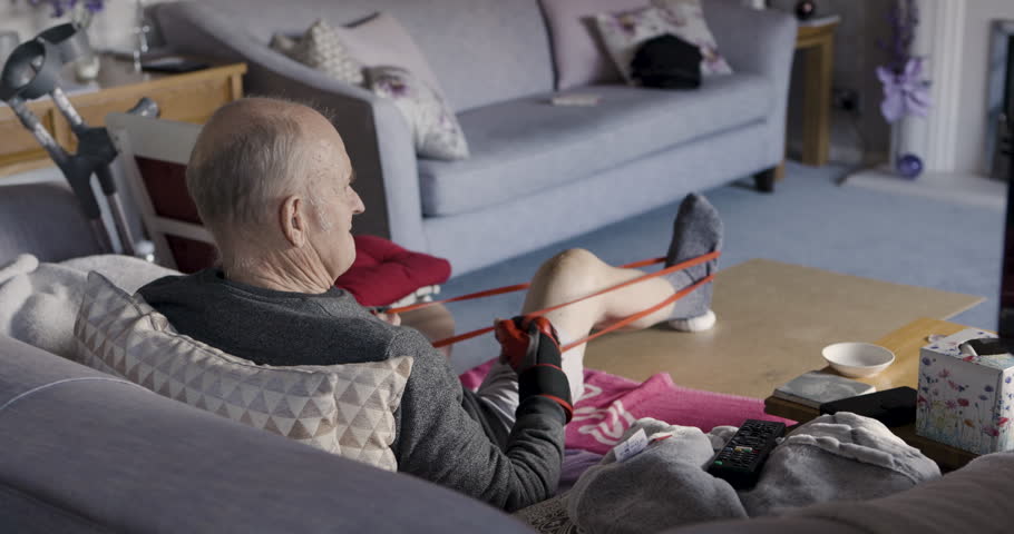 Senior man, resistance band and stretching for wellness, health and fitness in home, training and workout. Retirement, mature man and elastic band for rehabilitation, exercise and healthy recovery.