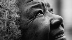 Wrinkled grateful Senior African American woman closing eyes in Prayer and meditation in black and white. One hopeful elderly black lady in 80s feeling FAITHFUL gazing UPWARDS - Powered by Shutterstock - Get 15% off with code: PIKWIZARD15