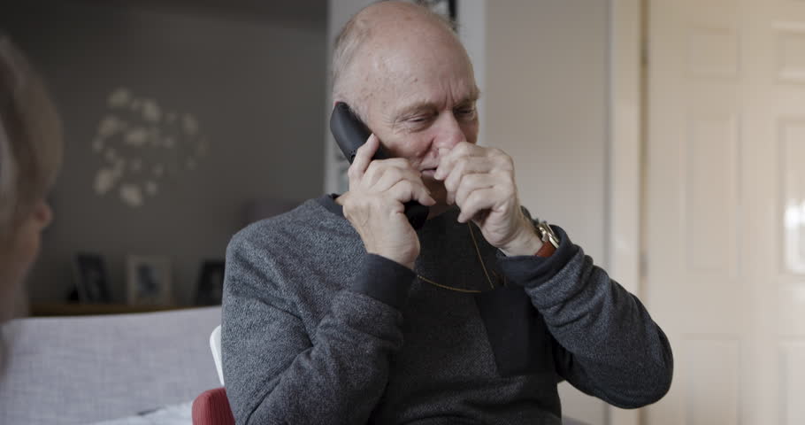 Phone call, physiotherapy and rehabilitation with senior man talking on telephone in retirement home. Healthcare, conversation and online doctor consultation of elderly male with multiple sclerosis