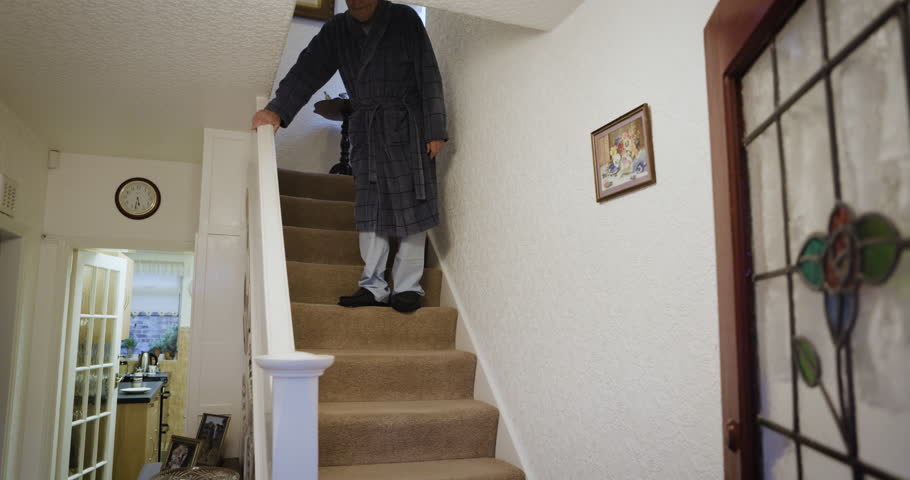 Senior man, walking or staircase in house or nursing home in surgery recovery healthcare, life insurance or medical support. Retirement elderly person, climbing steps or hand rail rehabilitation help