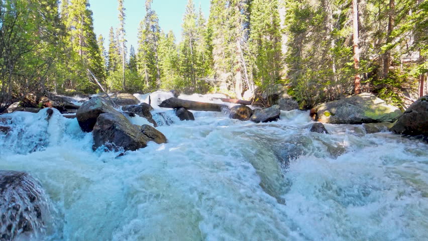 Low Angle of Water Rushing Through Colorado Creek In Rocky Mountain National Park