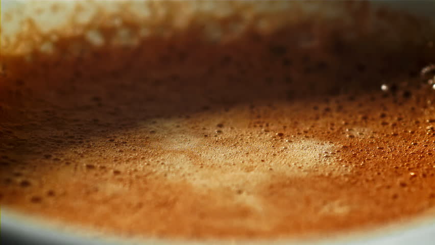 Falling drop in a cup of coffee. Filmed on a high-speed camera at 1000 fps. High quality FullHD footage