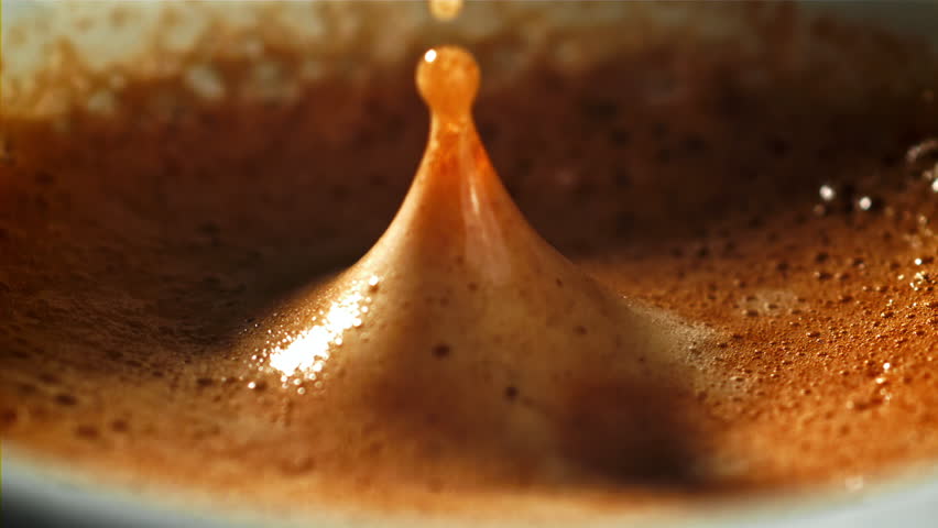 Falling drop in a cup of coffee. Filmed on a high-speed camera at 1000 fps. High quality FullHD footage