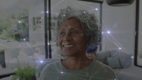 Senior woman smiling in technology living room, couple hugging on sofa, network nodes floating. Elderly, companionship, connectivity, cozy, social, home, warmth - Powered by Shutterstock - Get 15% off with code: PIKWIZARD15