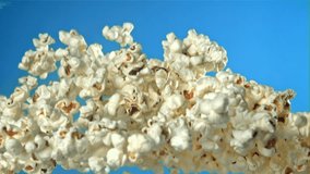 Popcorn flies up and falls down. On a blue background. Filmed on a high-speed camera at 1000 fps. High quality FullHD footage - Powered by Shutterstock - Get 15% off with code: PIKWIZARD15