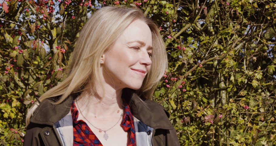 Happy woman, travel and smile for nature, fresh air or sunshine getting vitamin D by countryside. Female traveler smiling in joyful happiness and relaxation for calm, freedom or natural environment