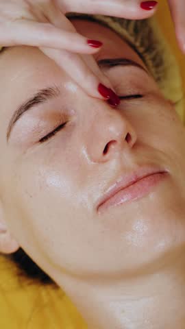 Cosmetology, facial massage. close-up. woman is lying on couch and getting facial massage, tonied muscles and facial skin lymphatic drainage, at beauty clinic. Skin care, anti-aging procedure. cosmeti