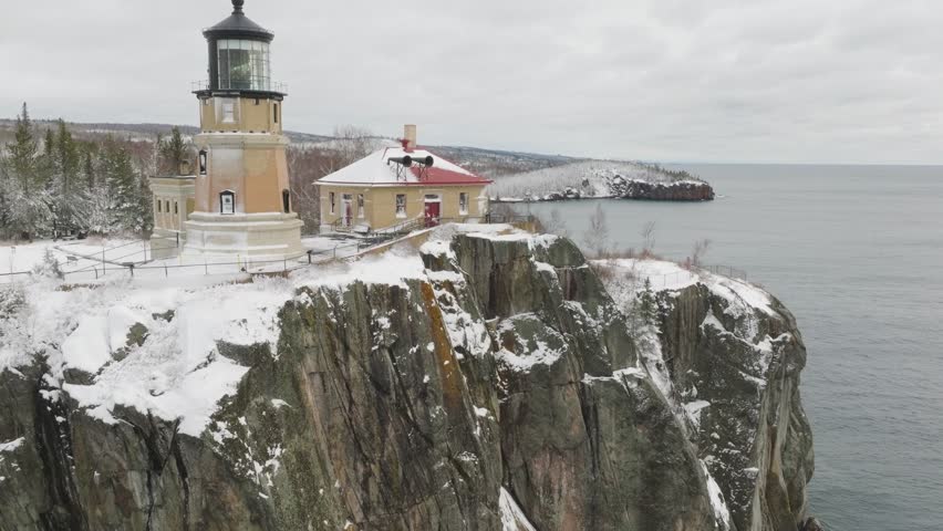 Split Rock Lighthouse On Top Of The Rocky Cliff During Winter. - aerial shot