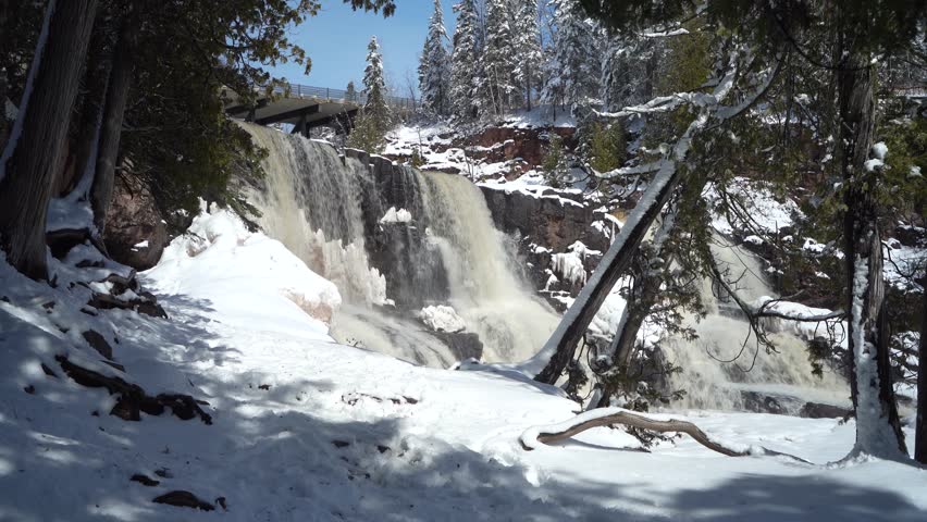 Cascading Waterfall And Snow-covered Trail At Gooseberry Falls State Park On Winter Day. Minnesota, USA. static shot