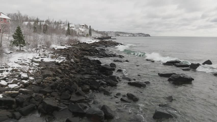 Waves Crashing Ashore On Lake Superior In Winter In Minnesota, USA. - aerial shot