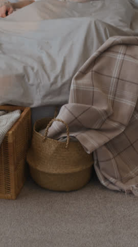 Vertical tilt up shot of senior man sleeping in his comfortable bed during early morning at home