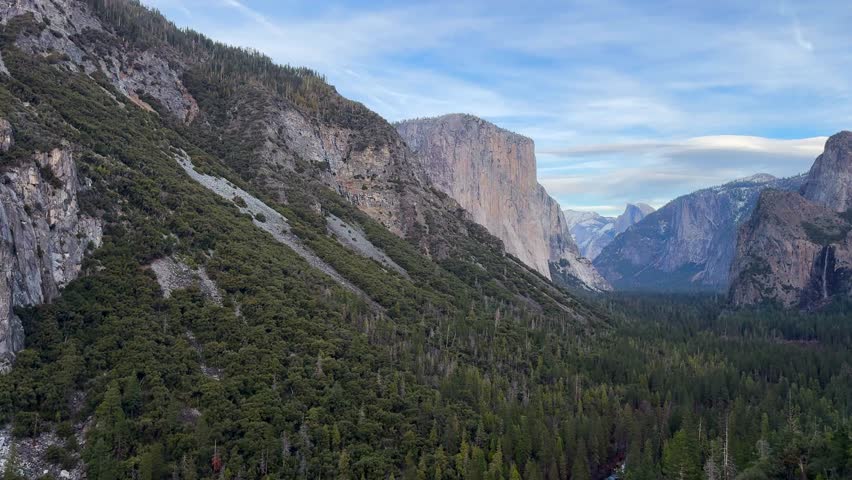 view over Yosemite Valley and El Capitan pine forest during evening time PAN RIGHT