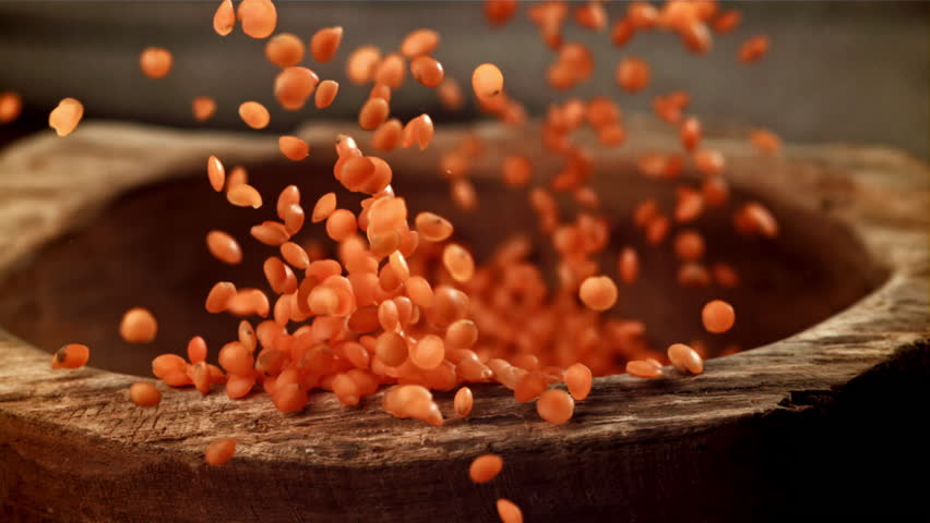 Lentils fall into a wooden bowl. Filmed on a high-speed camera at 1000 fps. High quality FullHD footage