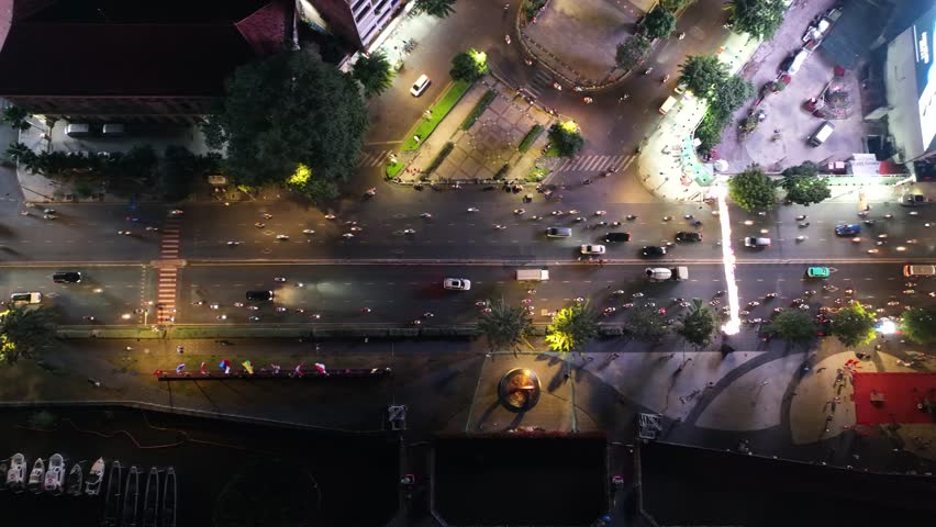 Busy street traffic on Ton Duc Thang, HCMC, Vietnam, with cars and pedestrians at night