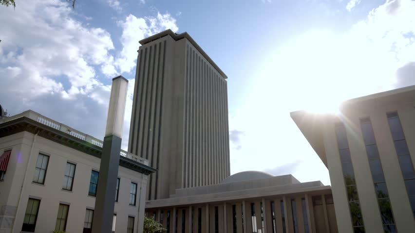 Florida state capitol building in Tallahassee, Florida with sun shining and video moving in.