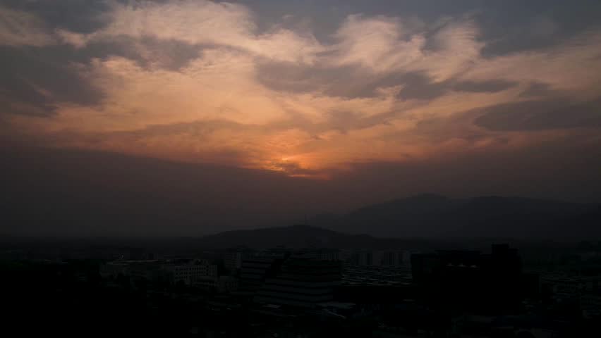 Fast-moving clouds over Islamabad with Margala Hills and city buildings at in the summer evening. Islamabad, Pakistan
