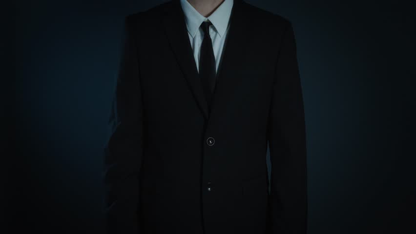 Businessman raising hand to chest, making an oath or pledge