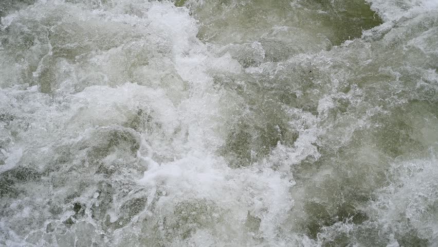 A swollen river. Floods in the spring. A lot of water flows in the river. Power of water.