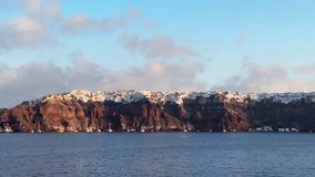 Santorini island, Greece. White architecture on the cliffs in Oia town. View from the sea at sunrise. Blue sea and the blue sky. Travel and summer vacation. 
 - Powered by Shutterstock - Get 15% off with code: PIKWIZARD15